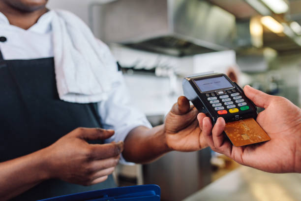 A man waiting to receive an invoice after using a POS machine, invoicing in Nigeria