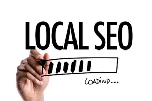 A hand writing a "Local SEO" text on a floating whiteboard