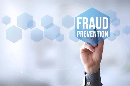 A human hand writing Fraud Prevention on a Smart board