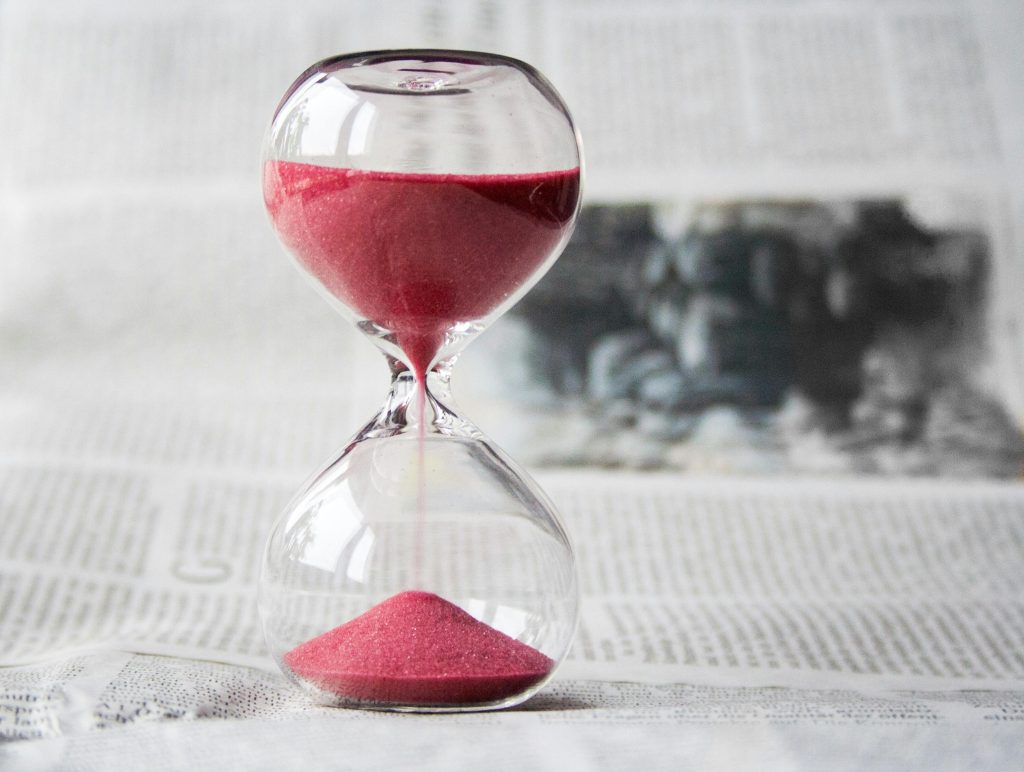 an hourglass with a red substance within it